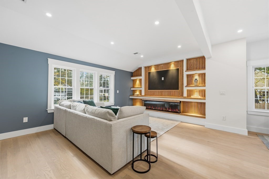 99 Grove Street Reading, MA 01867 - Photo 2 of 40 a living room with furniture and a flat screen tv