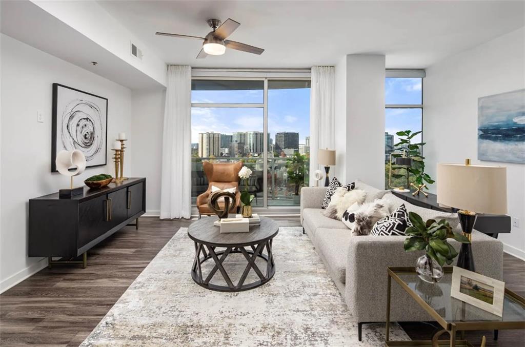 3242 Peachtree Road Northeast, Unit 301 Atlanta, GA 30305 - Photo 13 of 41 a living room with furniture and a large window
