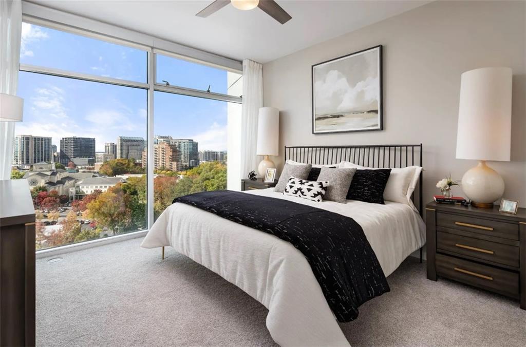 3242 Peachtree Road Northeast, Unit 301 Atlanta, GA 30305 - Photo 15 of 41 a bedroom with a large bed and a night stand