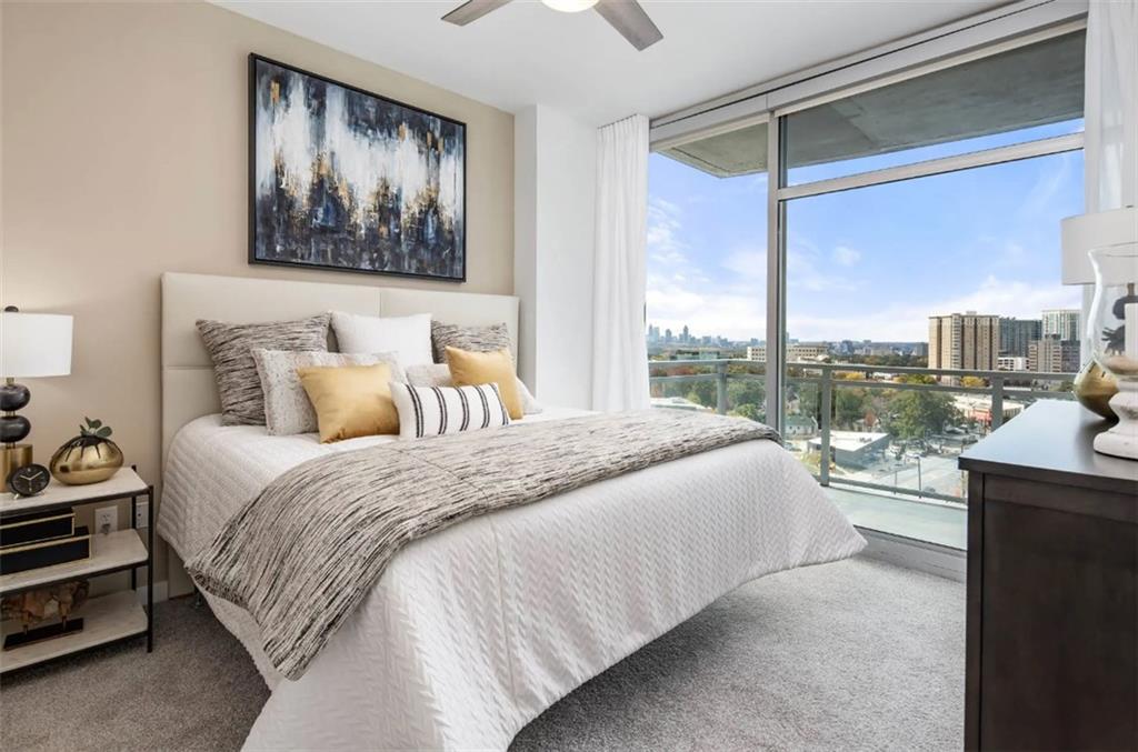 3242 Peachtree Road Northeast, Unit 301 Atlanta, GA 30305 - Photo 16 of 41 a bedroom with a large bed and a window