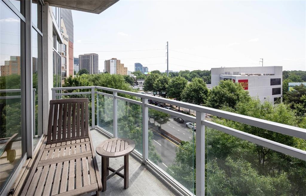 3242 Peachtree Road Northeast, Unit 301 Atlanta, GA 30305 - Photo 26 of 41 a view of a balcony with two chairs and a wooden fence