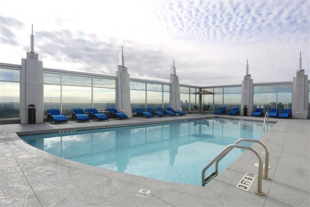 3242 Peachtree Road Northeast, Unit 301 Atlanta, GA 30305 - Photo 28 of 41 a view of a swimming pool and outdoor seating