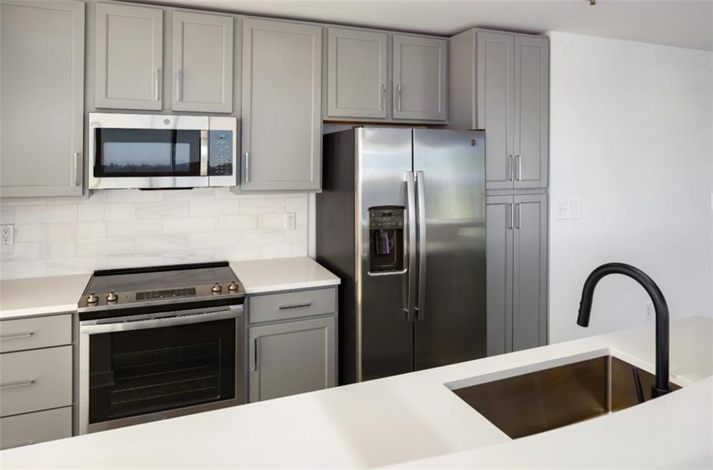 3242 Peachtree Road Northeast, Unit 301 Atlanta, GA 30305 - Photo 5 of 41 a kitchen with a stove and a microwave