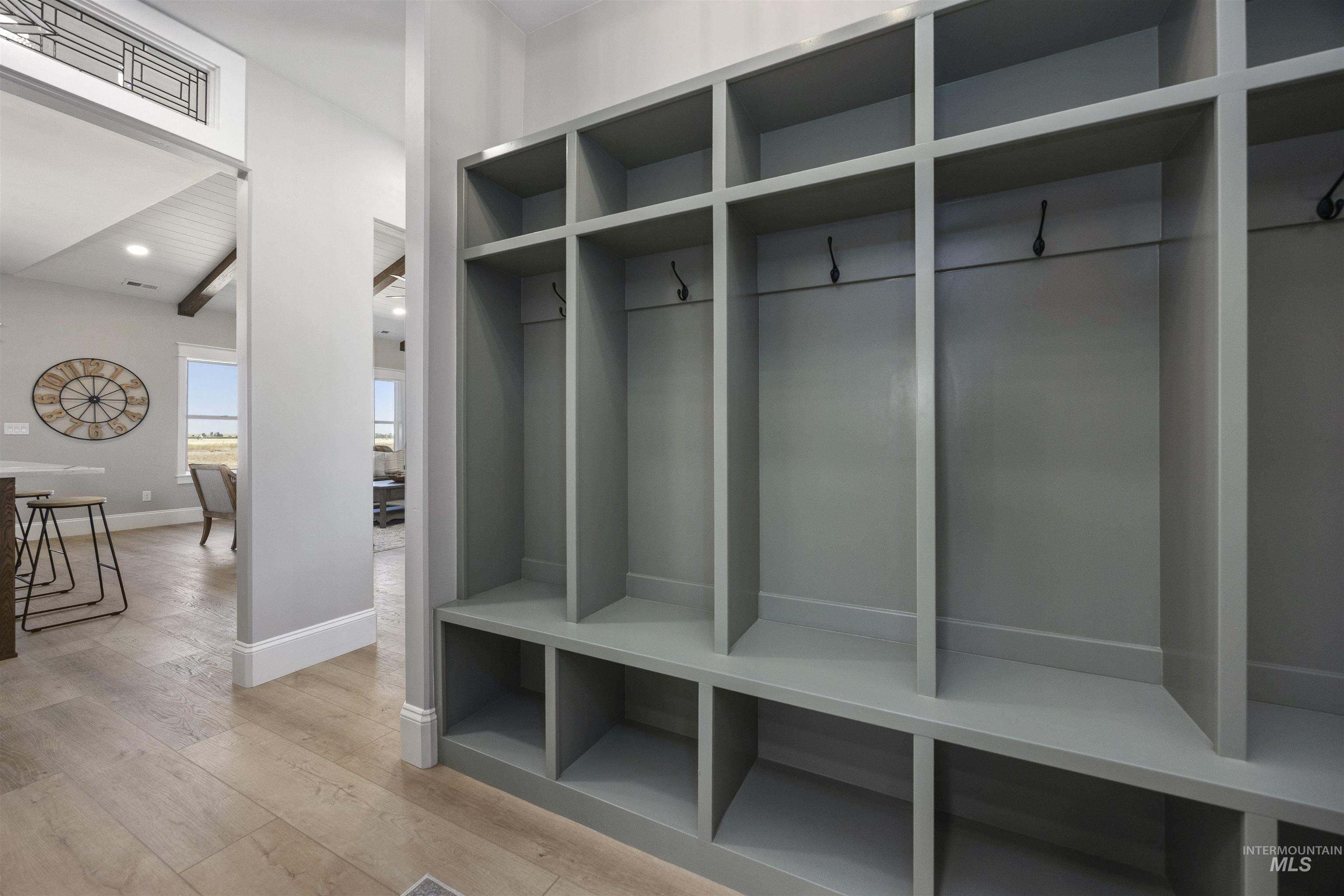 378 West 100 South Rupert, ID 83350 - Photo 36 of 50 Built-in storage cubbies featuring hooks and shelving, light wood-finish flooring, and white baseboards