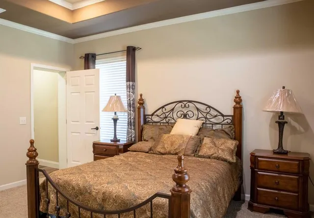 a bedroom with a bed and a dresser
