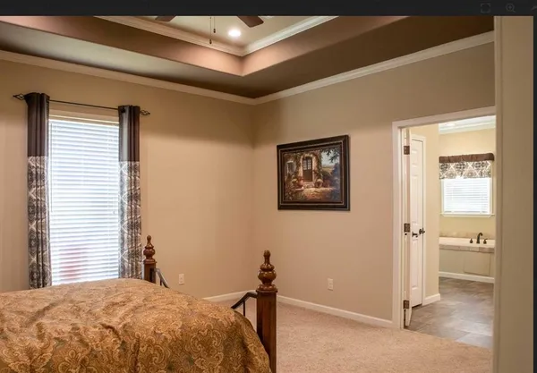 a bedroom with a bed and a painting on the wall