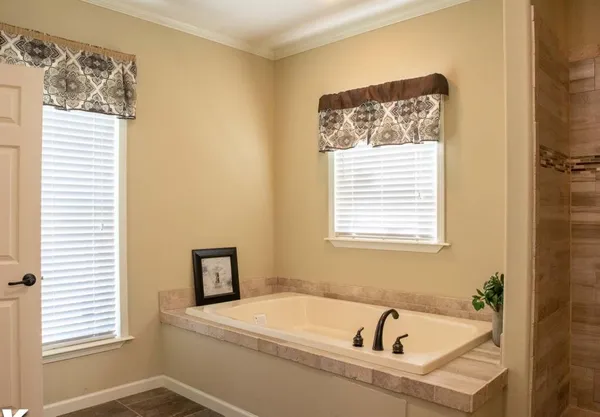 a bathroom with a bathtub and a window