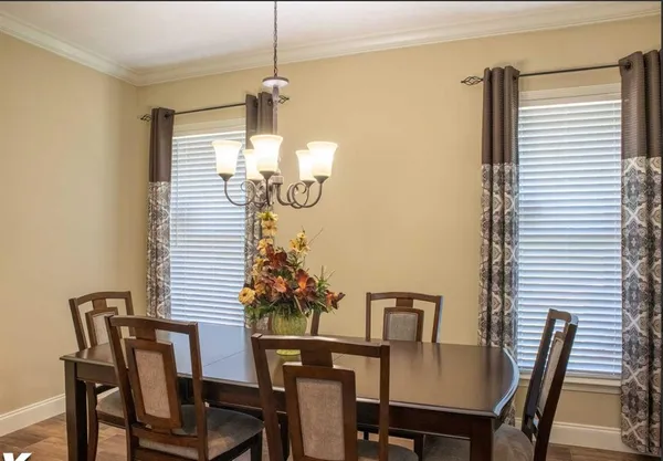 a dining room with furniture and window