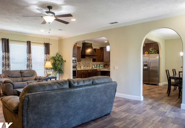 a living room with furniture and wooden floor