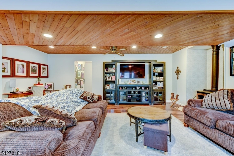 52 Ashburn Road Wayne, NJ 07470 - Photo 15 of 49 a living room with furniture and a flat screen tv