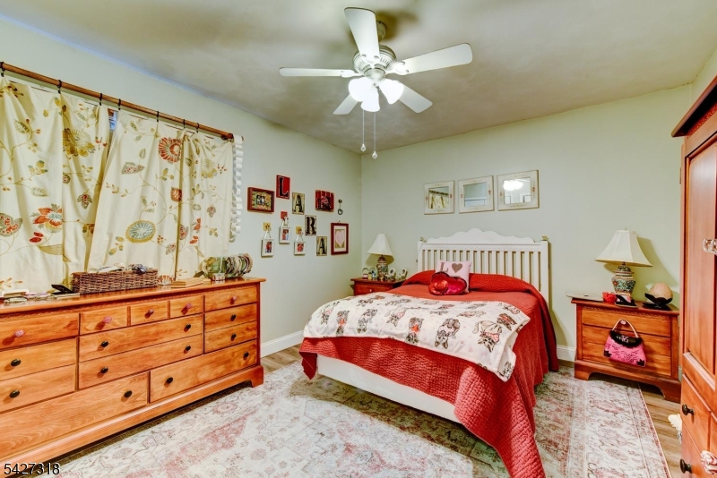 52 Ashburn Road Wayne, NJ 07470 - Photo 29 of 49 a bedroom with a bed and a dresser in it