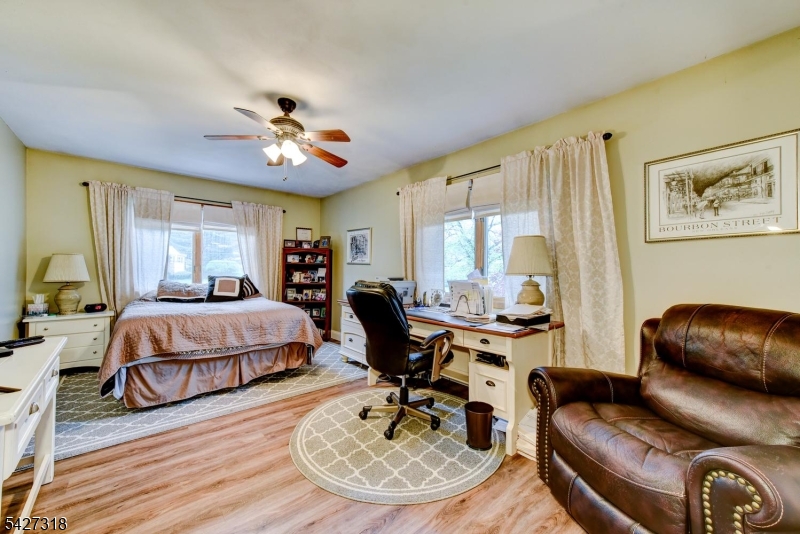 52 Ashburn Road Wayne, NJ 07470 - Photo 35 of 49 a living room with furniture a large window and a chandelier