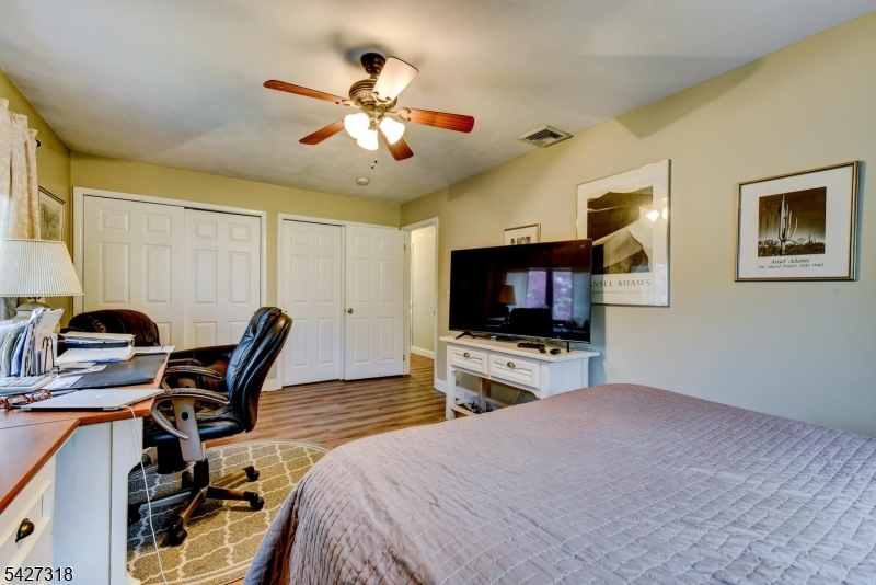 52 Ashburn Road Wayne, NJ 07470 - Photo 36 of 49 a bedroom with furniture and a flat screen tv