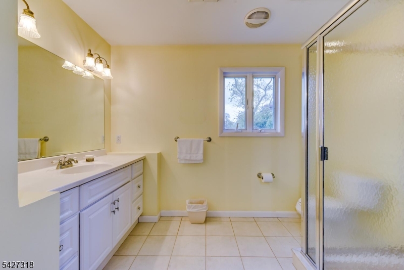 52 Ashburn Road Wayne, NJ 07470 - Photo 41 of 49 a spacious bathroom with a double vanity sink a mirror and a bathtub