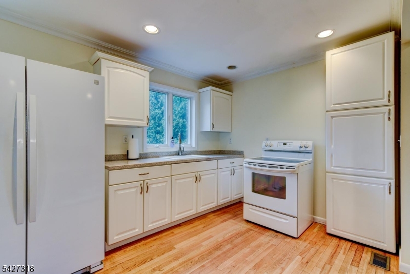 52 Ashburn Road Wayne, NJ 07470 - Photo 42 of 49 a kitchen with a refrigerator sink and cabinets