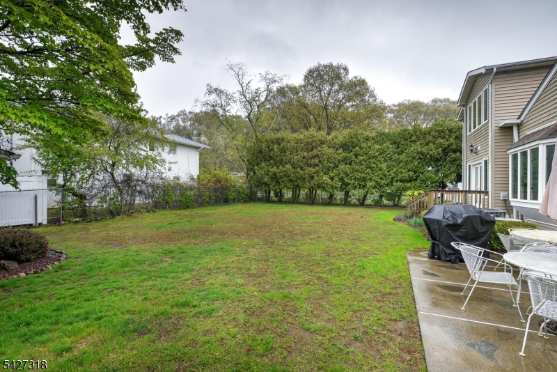 52 Ashburn Road Wayne, NJ 07470 - Photo 48 of 49 a backyard of a house with table and chairs