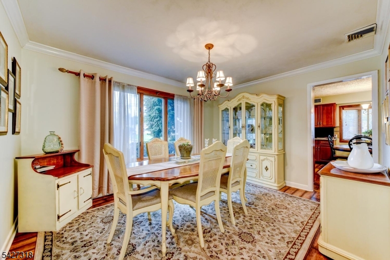 52 Ashburn Road Wayne, NJ 07470 - Photo 8 of 49 a view of a dining room with furniture and a chandelier