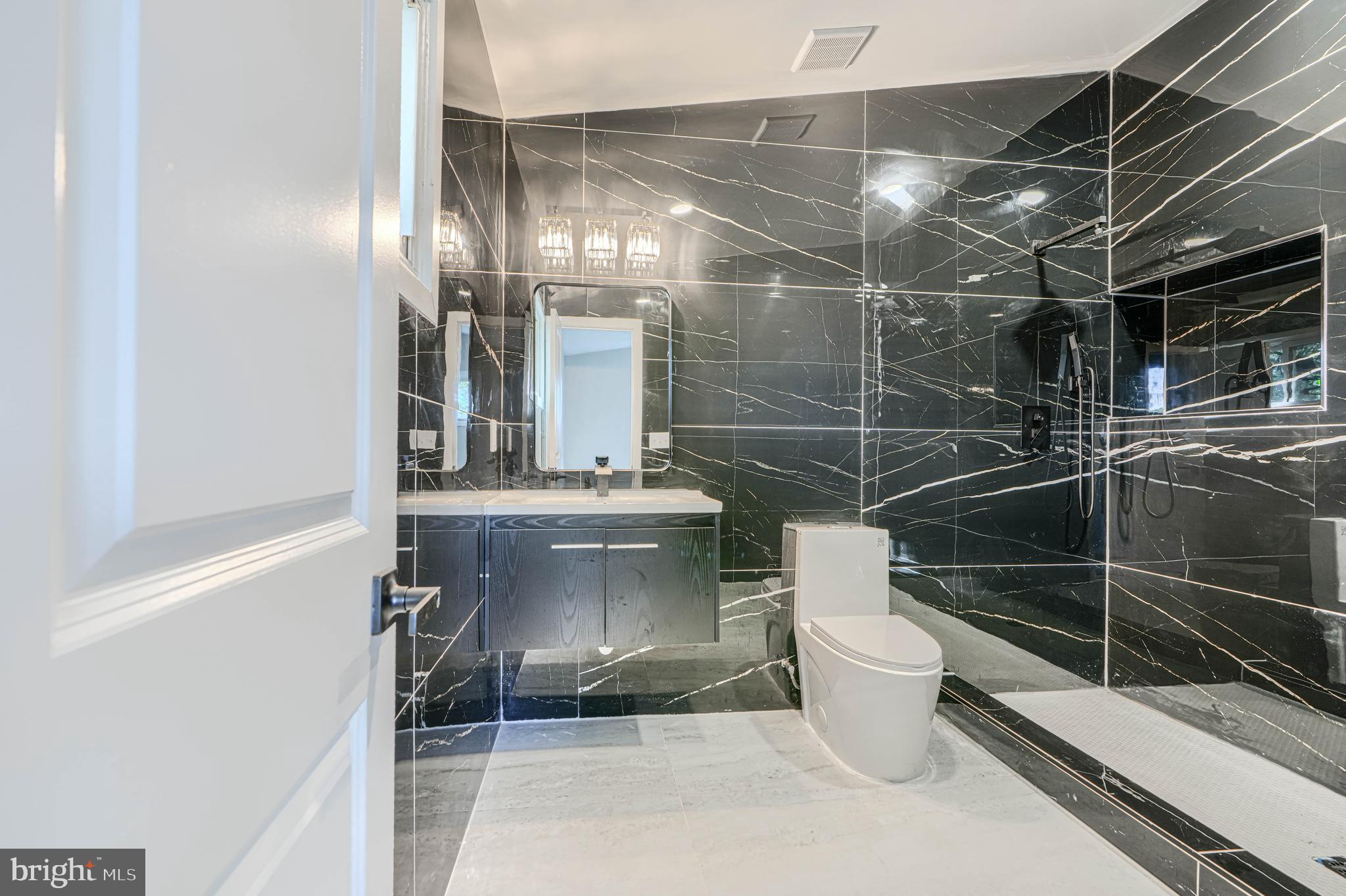 6200 Ivymount Road Baltimore, MD 21209 - Photo 42 of 71 a bathroom with a toilet a sink and shower