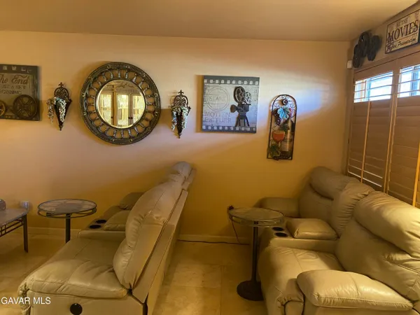 a bathroom with a blue tub and a mirror