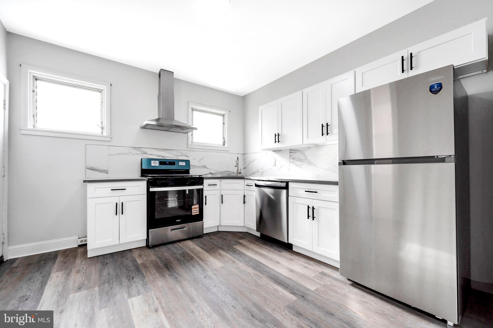 244 Wembly Road Upper Darby, PA 19082 - Photo 19 of 26 a kitchen with stainless steel appliances a refrigerator sink and cabinets