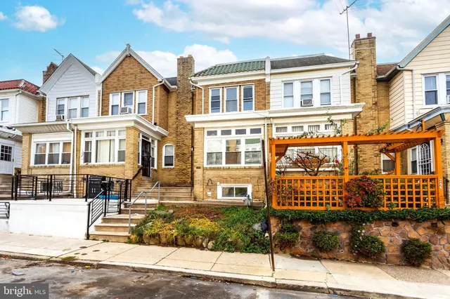 a front view of a residential apartment building with a yard