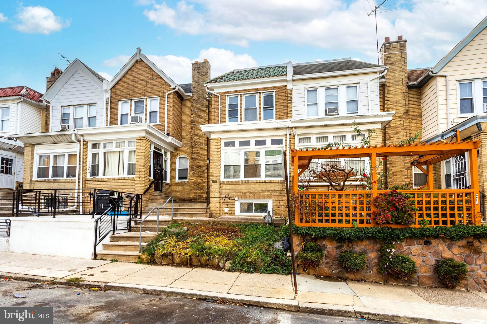 244 Wembly Road Upper Darby, PA 19082 - Photo 2 of 26 a front view of a residential apartment building with a yard