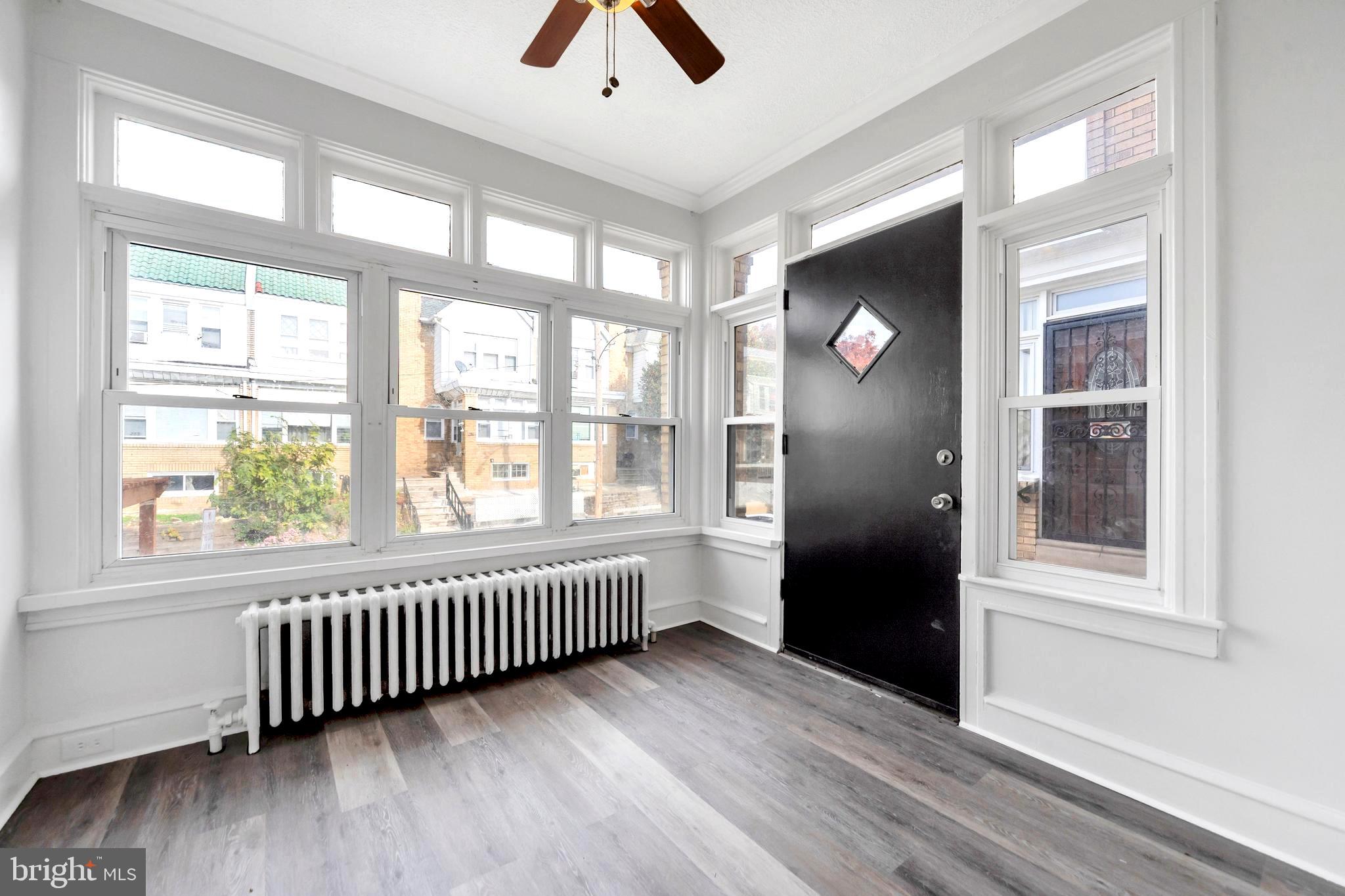 244 Wembly Road Upper Darby, PA 19082 - Photo 3 of 26 an empty room with wooden floor and windows