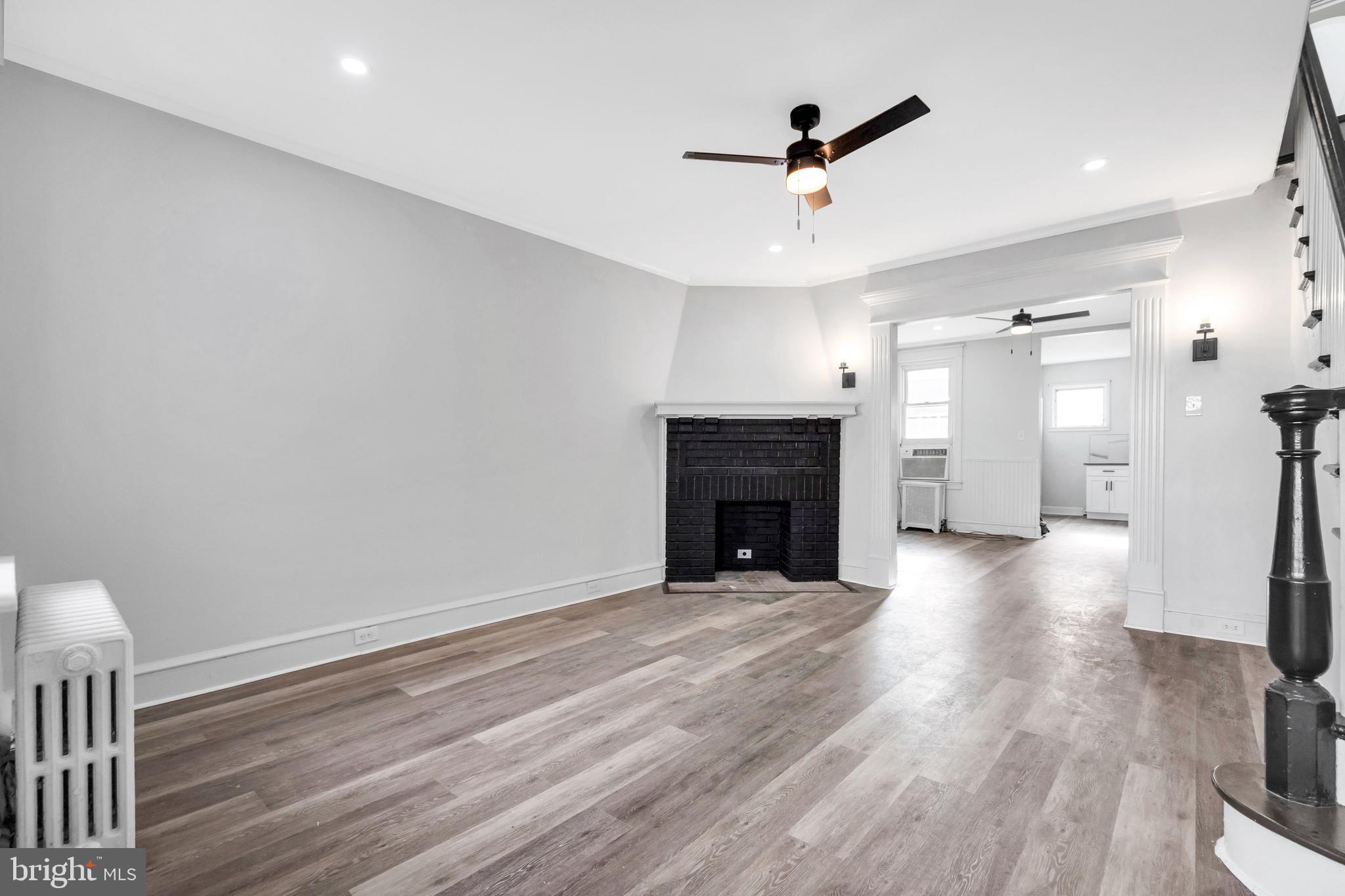 244 Wembly Road Upper Darby, PA 19082 - Photo 6 of 26 a view of empty room with wooden floor and fireplace