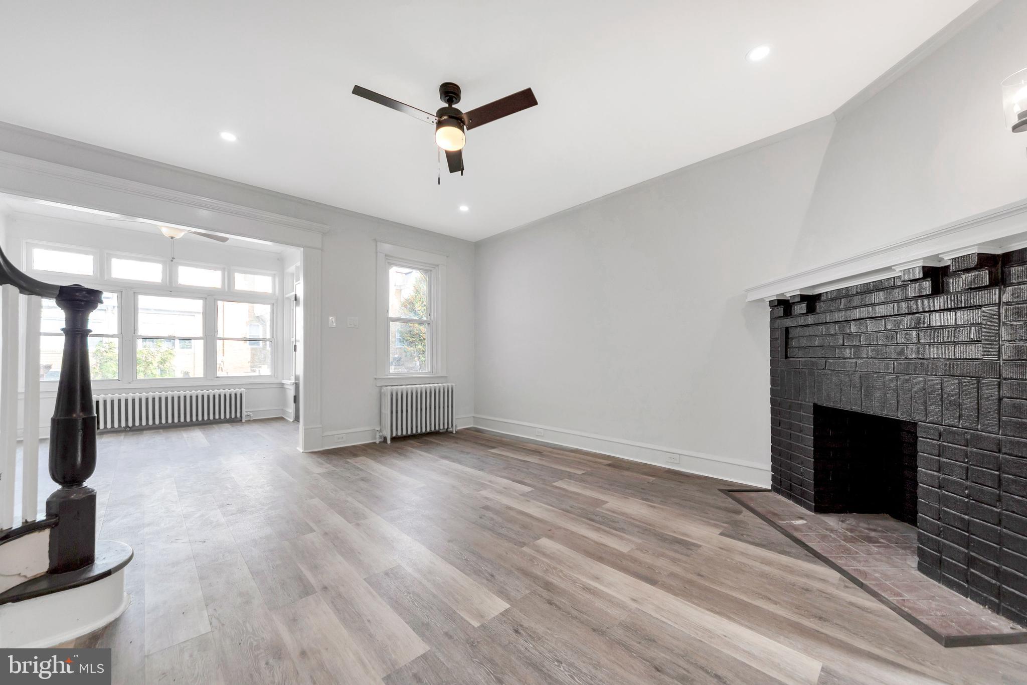 244 Wembly Road Upper Darby, PA 19082 - Photo 7 of 26 an empty room with windows and fireplace
