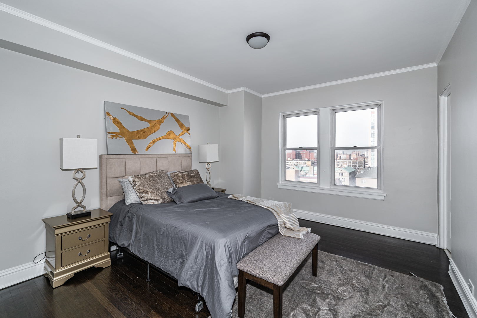 5510 North Sheridan Road, Unit 10A Chicago, IL 60640 - Photo 18 of 40 a bedroom with a bed and a dresser next to a window