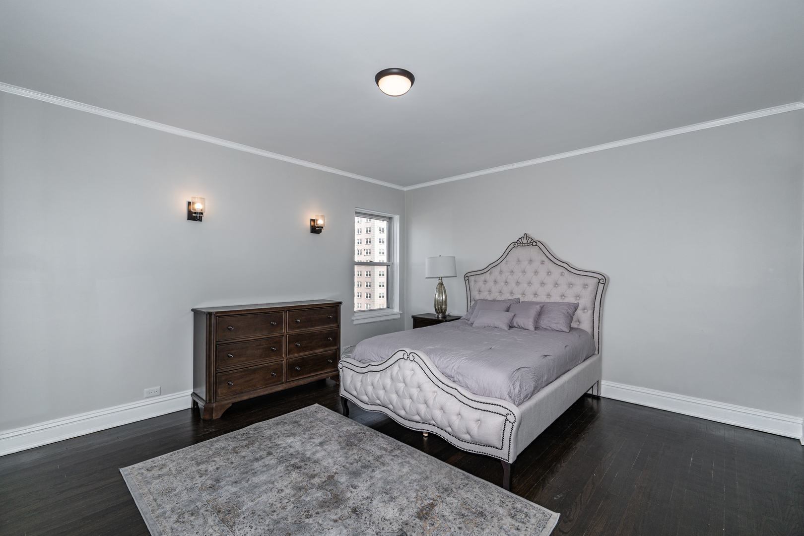 5510 North Sheridan Road, Unit 10A Chicago, IL 60640 - Photo 19 of 40 a bedroom with a bed and a dresser