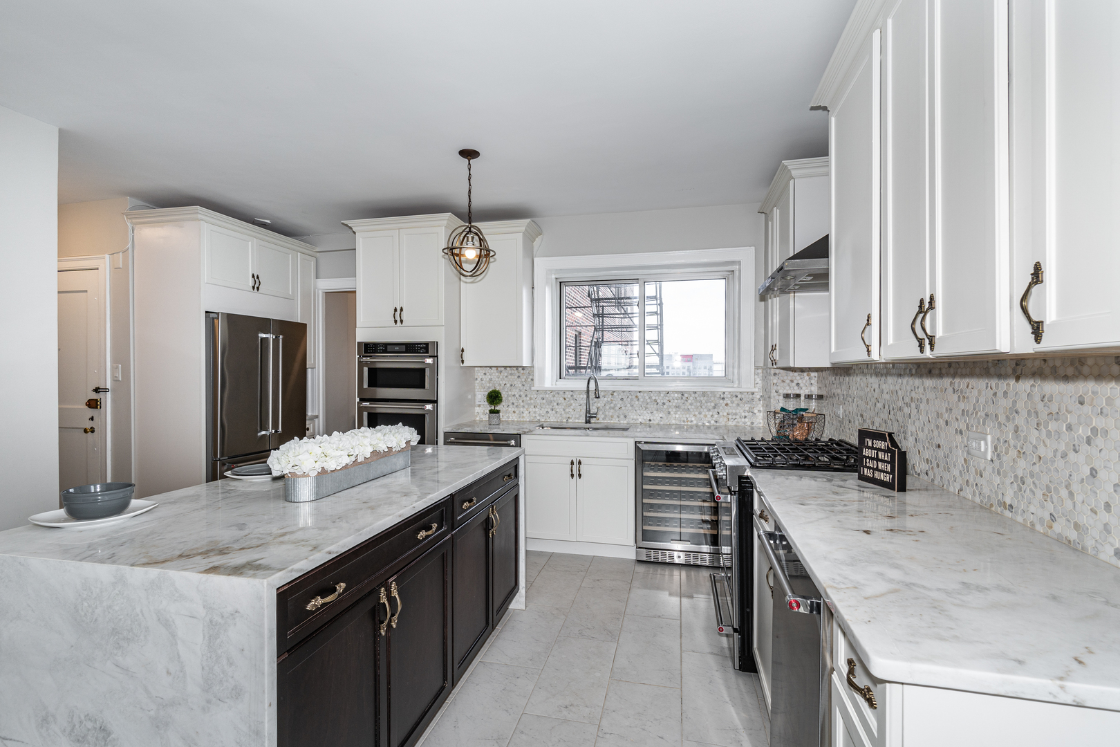 5510 North Sheridan Road, Unit 10A Chicago, IL 60640 - Photo 6 of 40 a kitchen with a sink stove top oven and refrigerator