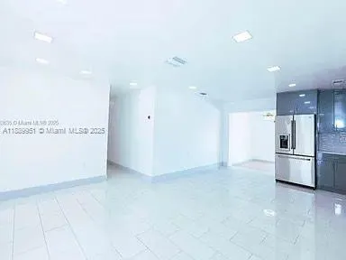 a view of kitchen with refrigerator and microwave