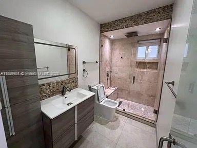 14331 Southwest 286th Street Homestead, FL 33033 - Photo 13 of 18 a bathroom with a sink a toilet a mirror and shower