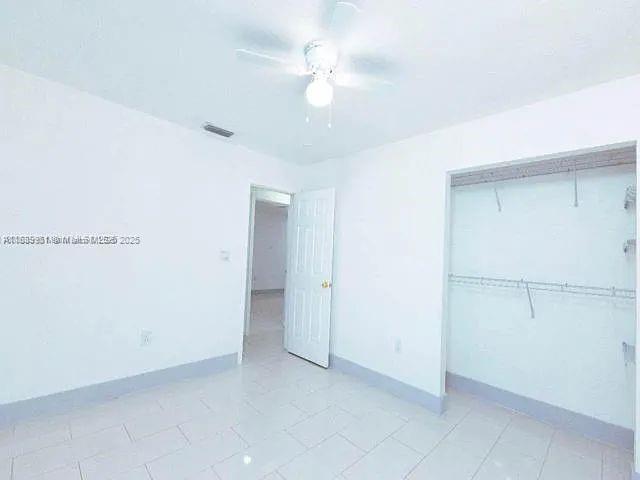 14331 Southwest 286th Street Homestead, FL 33033 - Photo 15 of 18 an empty room with a ceiling fan and a window