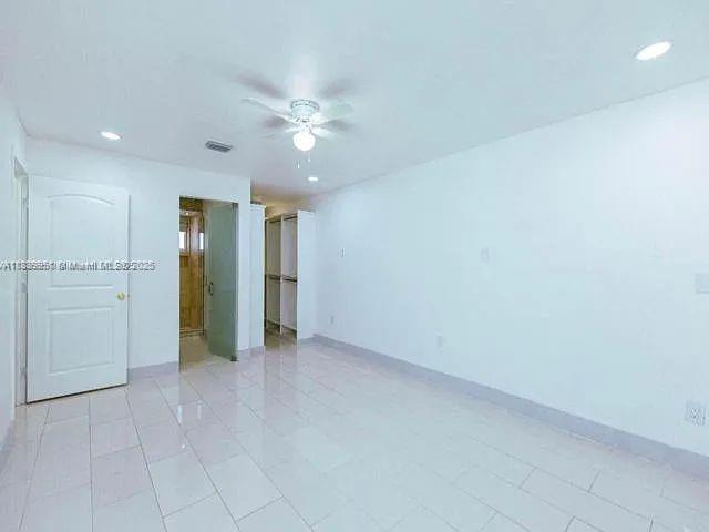 14331 Southwest 286th Street Homestead, FL 33033 - Photo 7 of 18 an empty room with closet and fan