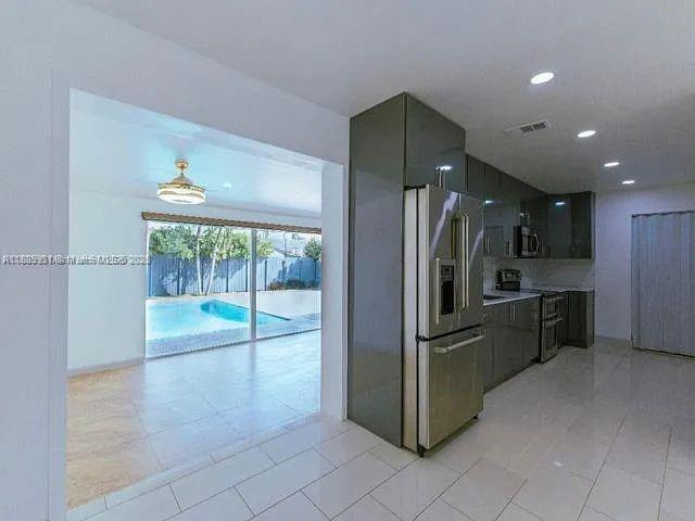 14331 Southwest 286th Street Homestead, FL 33033 - Photo 10 of 18 a kitchen with stainless steel appliances granite countertop a refrigerator and a sink