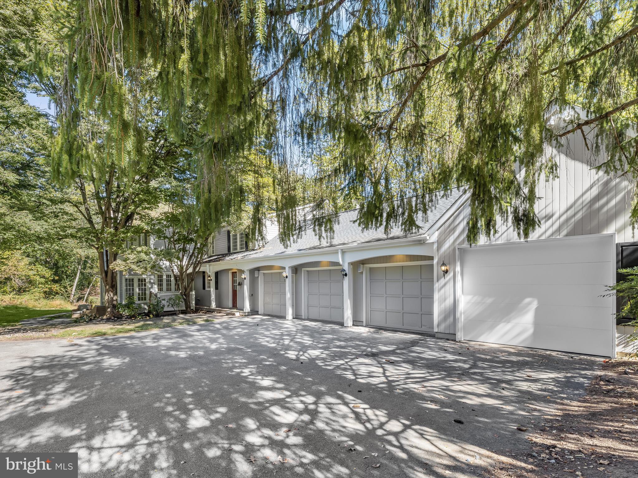 5708 Emory Road Upperco, MD 21155 - Photo 2 of 78 a view of a white house next to a yard with large trees