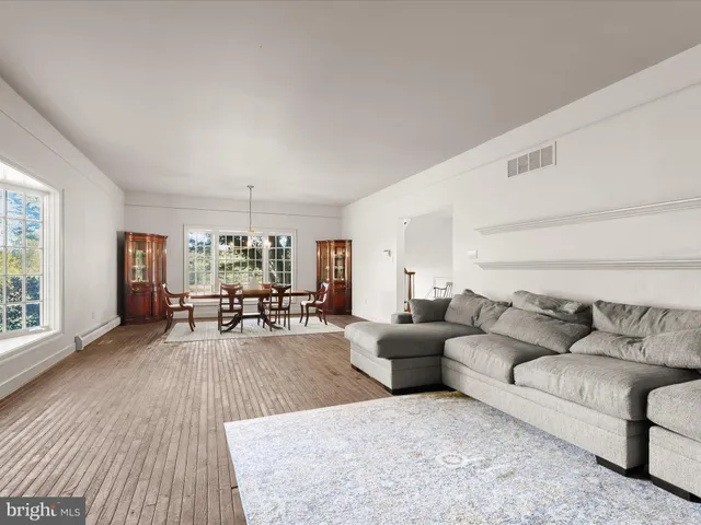 a spacious bathroom with a double vanity sink a mirror and a shower