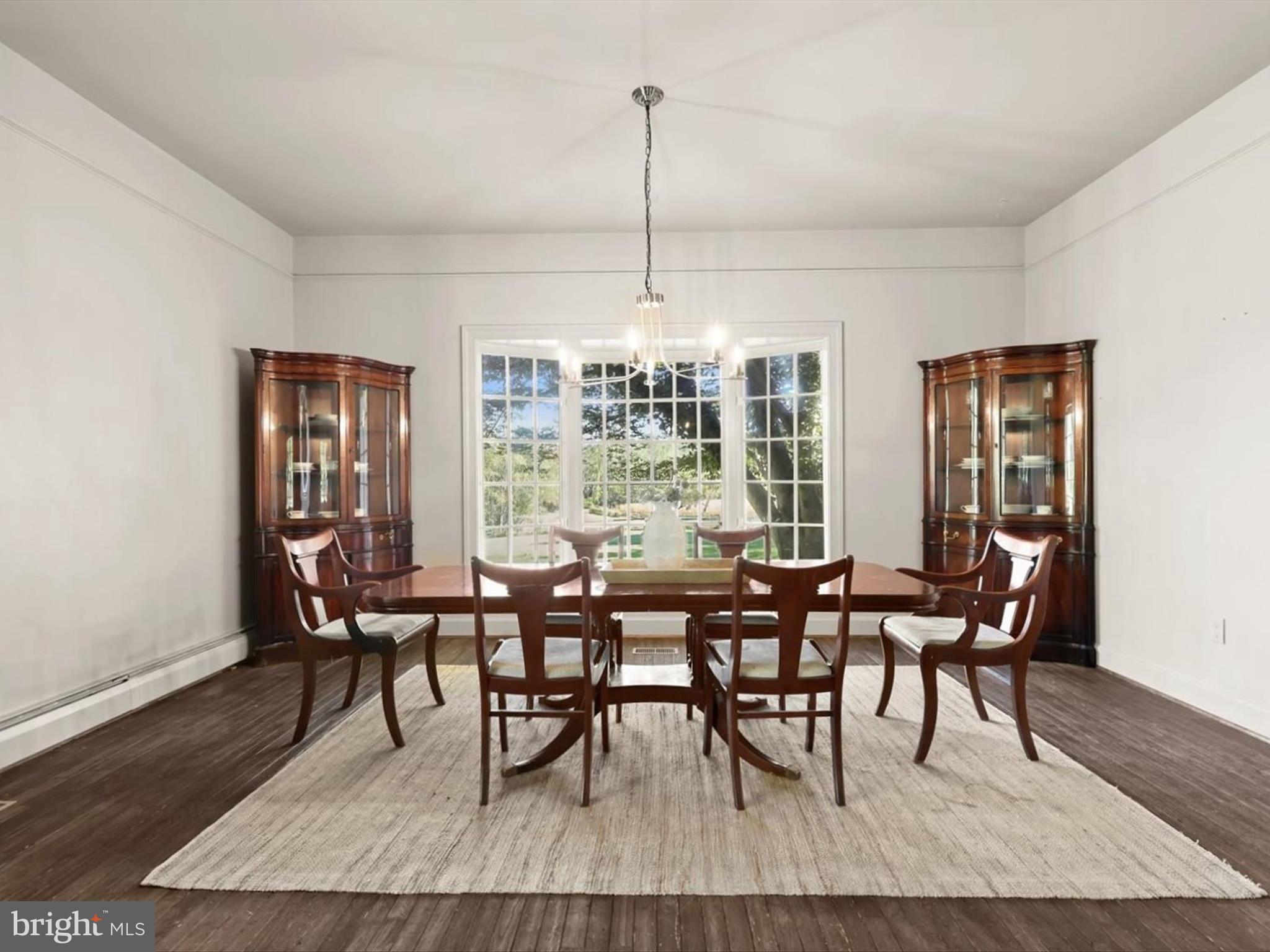 5708 Emory Road Upperco, MD 21155 - Photo 34 of 78 a dining room with furniture wooden floor a rug and a chandelier