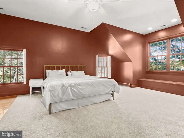 a view of a yard in front of a house with large trees