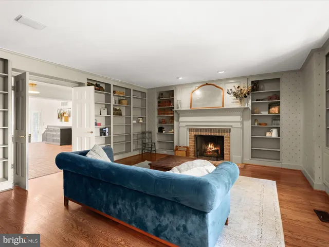 a kitchen that has a lot of white cabinets and stainless steel appliances