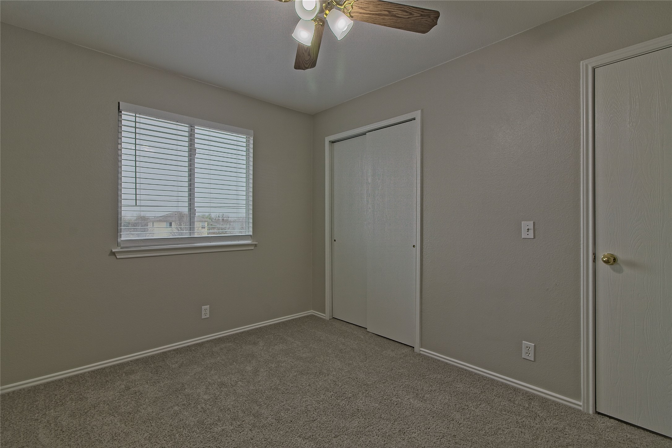 232 Brickyard Lane Jarrell, TX 76537 - Photo 24 of 31 A well-lit bedroom features plush carpeting and convenient closet access, creating a comfortable personal retreat.