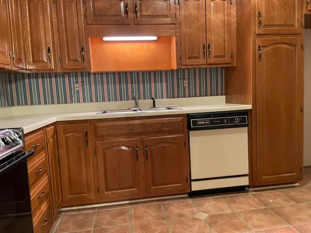 a kitchen with granite countertop a stove and a microwave oven