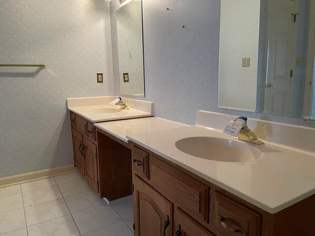 a bathroom with a sink and mirror