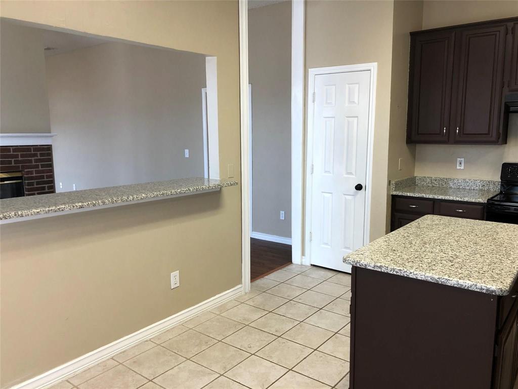 8301 Bells Street Frisco, TX 75035 - Photo 12 of 24 a kitchen with granite countertop cabinets and sink