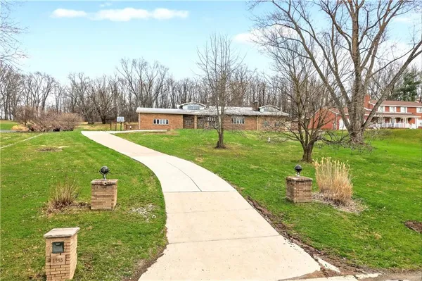 a kitchen with stainless steel appliances granite countertop a sink a stove top oven a counter space and cabinets