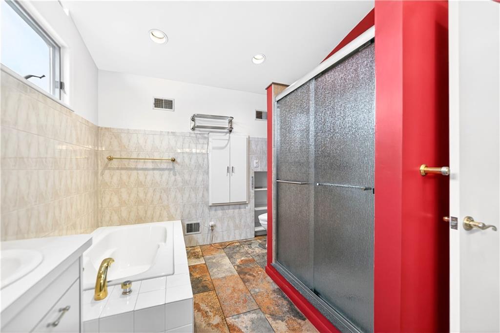 1443 Stoltz Road Bethel Park, PA 15102 - Photo 36 of 49 a bathroom with a bathtub and a shower