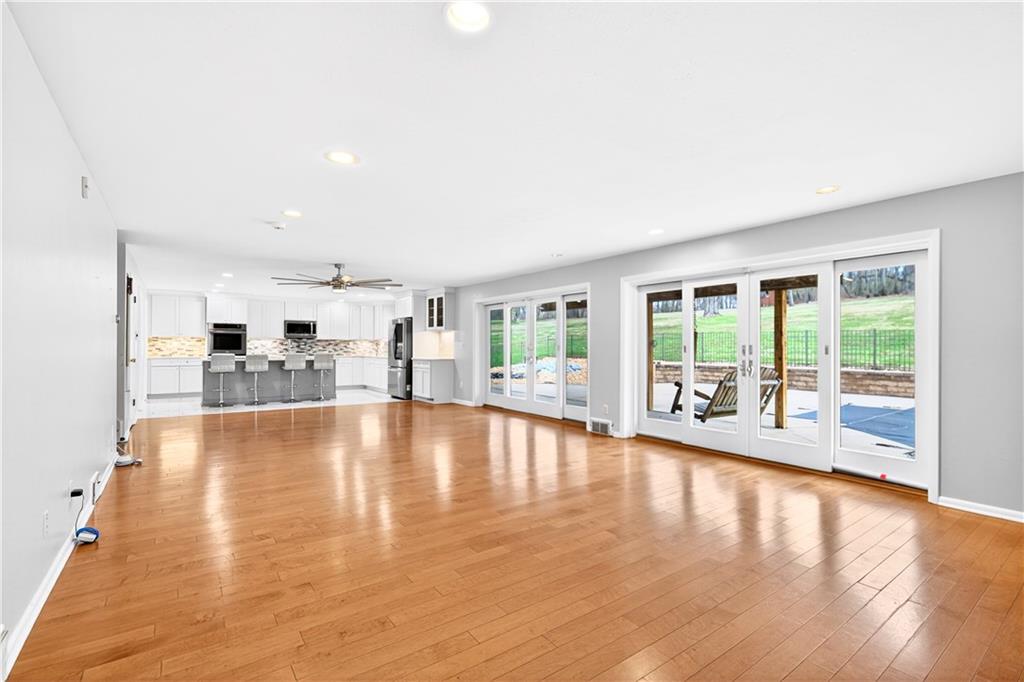 1443 Stoltz Road Bethel Park, PA 15102 - Photo 4 of 49 a view of empty room with wooden floor and floor to ceiling window