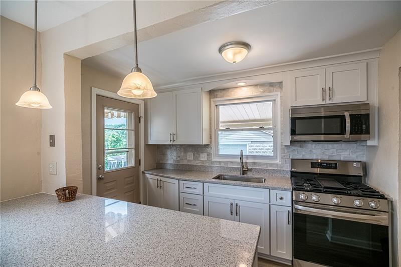 925 Greenhill Road Pittsburgh, PA 15209 - Photo 2 of 27 a kitchen with stainless steel appliances granite countertop a stove a sink and a microwave